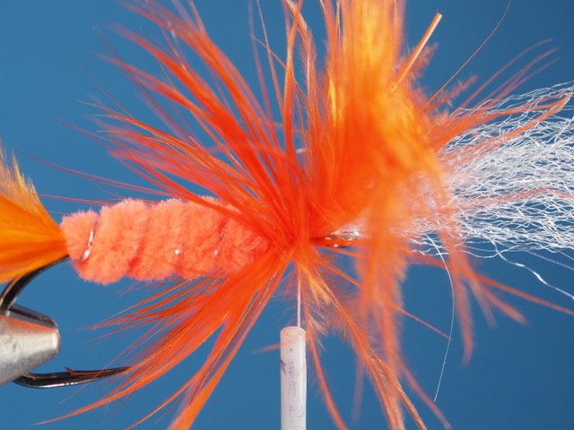 I will reach in here to the middle of this ungainly mess, carefully cutting the stem of the scghlappen feather, and take a few extra touching wraps of thread to secure the trimmed feather stem. Careful not to cut the thread!